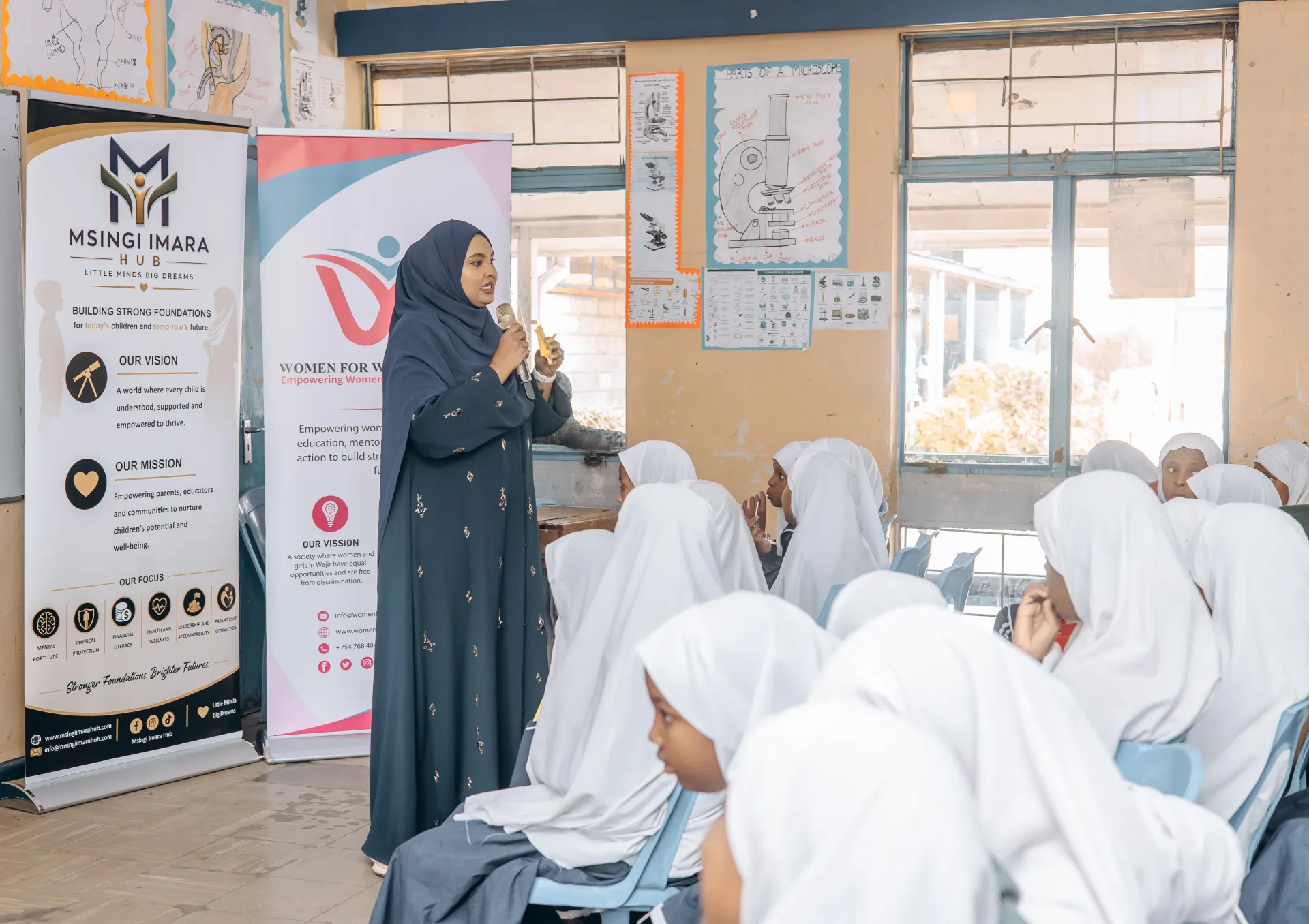 A Women for Women Alliance facilitator speaking to students during a health session